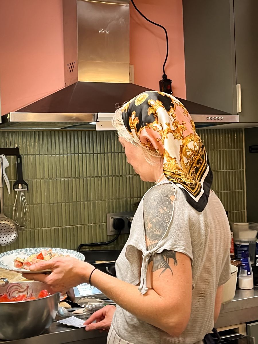 A guest at a private event, feeling at home, cooking in the Hora Mansa kitchen.