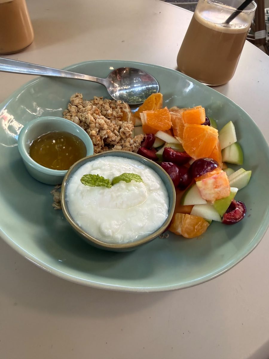 Orchard Crunch Bowl — creamy Greek yogurt, toasted granola, honey and seasonal fruit in a sage-green bowl.